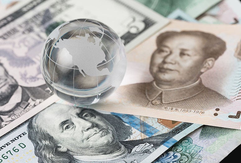 US and Chinese Currency with Glass globe on top