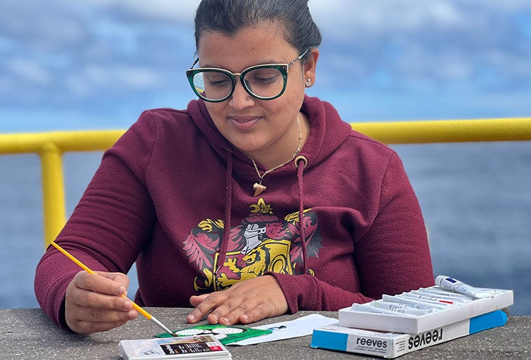 Rice Ph.D. student Debadrita Jana painting microfossils aboard the research vessel JOIDES Resolution in February 2022