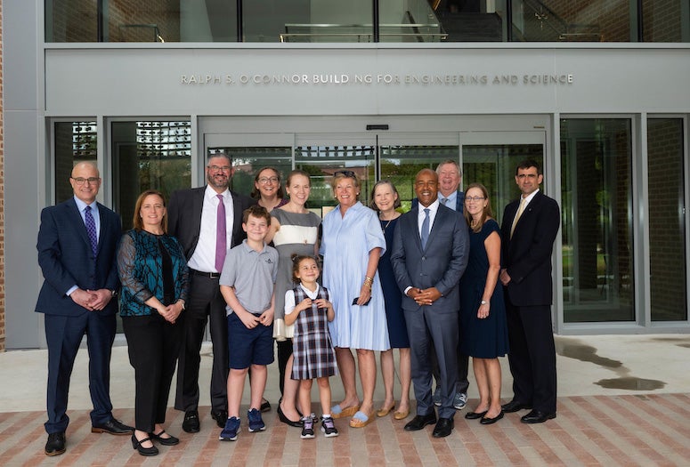 group posing outside of the O'Connor building