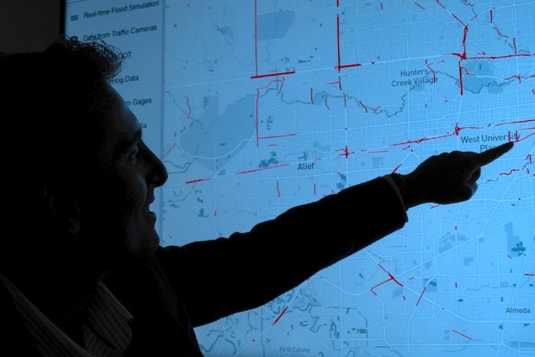  Pranavesh Panakkal, a postdoctoral researcher in civil and environmental engineering, analyzes data in Houston that senses road conditions during a flood situation.