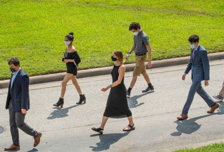 Incoming Rice students stride toward the Sallyport for matriculation, which ran all day long to accommodate social distancing measures and allow plenty of room for each college to march through the quad. (Photo by Tommy LaVergne)