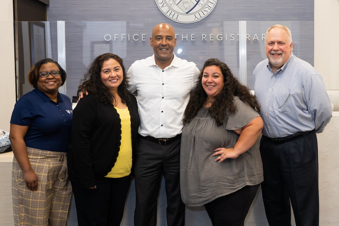 DesRoches smiles for a photo with Registrar's Office staff.