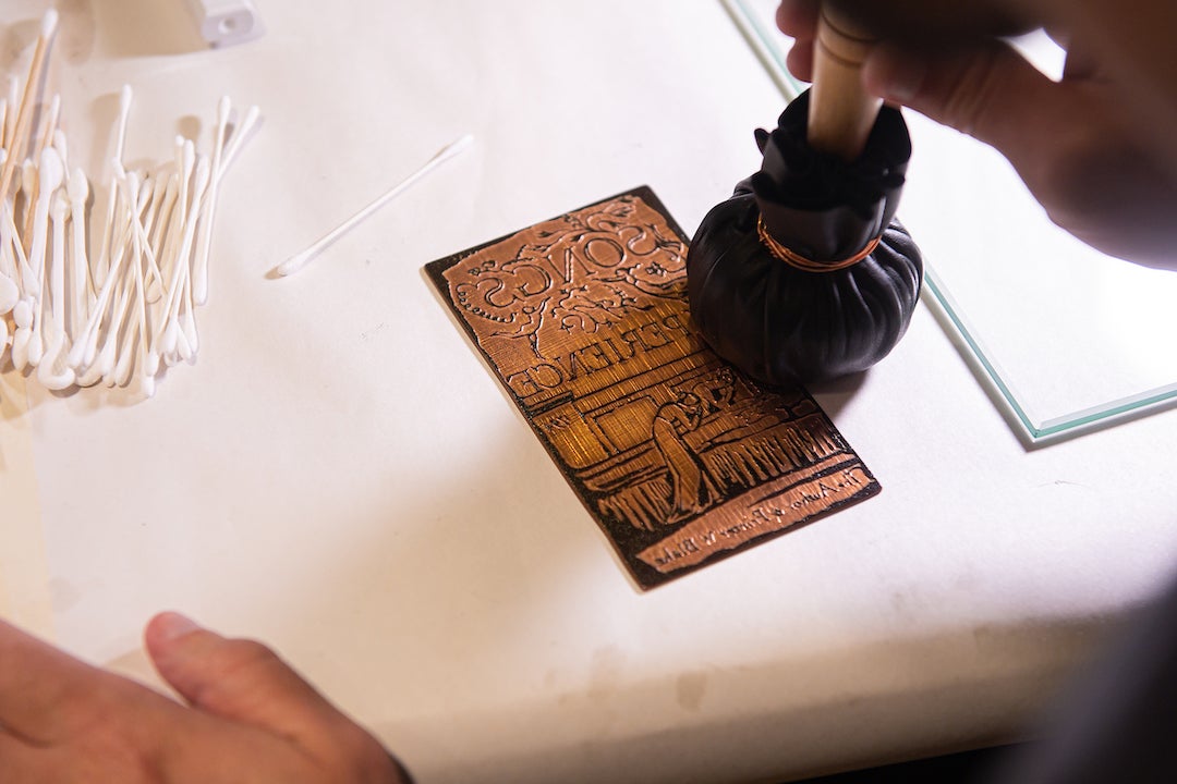 Renowned William Blake scholar and printmaker Michael Phillips shows students the printmaking process during a showcase of the newly-acquired star-wheel copper-plate rolling press at the Woodson Research Center in Fondren Library on March 1, 2023.