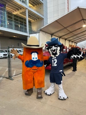 Photo of Sammy the Owl in a cowboy hat and Howdy, the Rodeo Houston mascot.